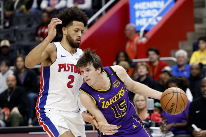 Nov 4, 2024; Detroit, Michigan, USA; Los Angeles Lakers guard Austin Reaves (15) dribbles defended by Detroit Pistons guard Cade Cunningham (2) in the first half at Little Caesars Arena. Mandatory Credit: Rick Osentoski-Imagn Images