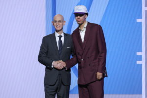 Jun 25, 2025; Brooklyn, NY, USA; Will Riley stands with NBA commissioner Adam Silver after being selected as the 21st pick by the Utah Jazz in the first round of the 2025 NBA Draft at Barclays Center. Mandatory Credit: Brad Penner-Imagn Images