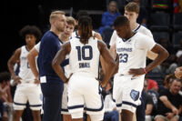 Oct 11, 2025; Memphis, Tennessee, USA; Memphis Grizzlies head coach Tuomas Iisalo huddles with guard Cam Spencer (24), guard Javon Small (10), forward Cedric Coward (23) and center Lawson Lovering (34) during a timeout during the second quarter against the Atlanta Hawks at FedExForum. Mandatory Credit: Petre Thomas-Imagn Images