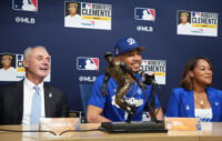 Oct 27, 2025; Los Angeles, California, USA; Los Angeles Dodgers shortstop Mookie Betts (50) is awarded the Roberto Clemente Award by Major League Basesball commissioner Rob Manfred as his wife, Brianna Betts, sits beside him before game three of the 2025 MLB World Series against the Toronto Blue Jays at Dodger Stadium. Mandatory Credit: Kirby Lee-Imagn Images