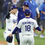 Oct 27, 2025; Los Angeles, California, USA; Los Angeles Dodgers designated hitter Shohei Ohtani (17) celebrates with pitcher Roki Sasaki (11) and pitcher Yoshinobu Yamamoto (18) after winning in the eighteenth inning against the Toronto Blue Jays in game three of the 2025 MLB World Series at Dodger Stadium. Mandatory Credit: Kiyoshi Mio-Imagn Images