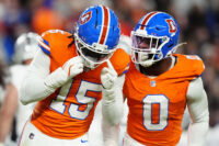 Nov 6, 2025; Denver, Colorado, USA; Denver Broncos linebacker Nik Bonitto (15) and linebacker Jonathon Cooper (0) react during the first half at Empower Field at Mile High. Mandatory Credit: Ron Chenoy-Imagn Images