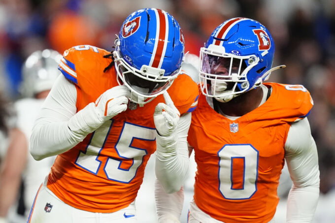 Nov 6, 2025; Denver, Colorado, USA; Denver Broncos linebacker Nik Bonitto (15) and linebacker Jonathon Cooper (0) react during the first half at Empower Field at Mile High. Mandatory Credit: Ron Chenoy-Imagn Images