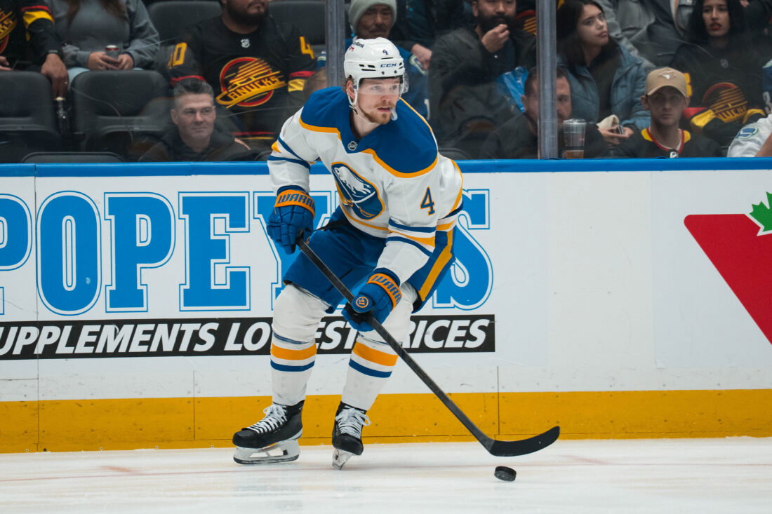Dec 11, 2025; Vancouver, British Columbia, CAN; Buffalo Sabres defenseman Bowen Byram (4) handles the puck against the Vancouver Canucks in the first period at Rogers Arena. Mandatory Credit: Bob Frid-Imagn Images