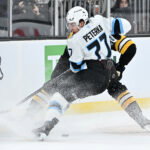 Dec 16, 2025; Boston, Massachusetts, USA; Utah Mammoth right wing JJ Peterka (77) battles with Boston Bruins defenseman Nikita Zadorov (91) for the puck during the second period at TD Garden. Mandatory Credit: Eric Canha-Imagn Images