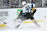 Dec 16, 2025; Boston, Massachusetts, USA; Utah Mammoth right wing JJ Peterka (77) battles with Boston Bruins defenseman Nikita Zadorov (91) for the puck during the second period at TD Garden. Mandatory Credit: Eric Canha-Imagn Images