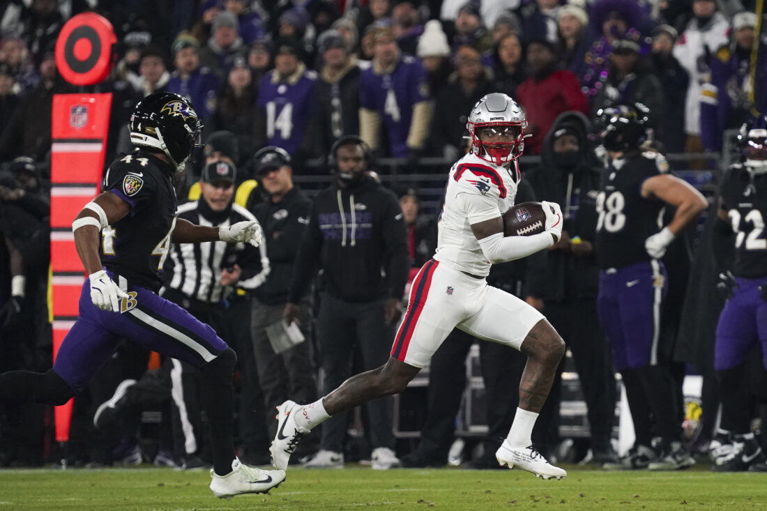 Dec 21, 2025; Baltimore, Maryland, USA; New England Patriots wide receiver Stefon Diggs (8) runs after a catch against Baltimore Ravens cornerback Marlon Humphrey (44) during the first half of the game at M&T Bank Stadium. Mandatory Credit: James Lang-Imagn Images