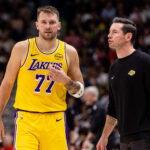 Jan 6, 2026; New Orleans, Louisiana, USA; Los Angeles Lakers forward/guard Luka Doncic (77) talks to Head Coach JJ Redick against the New Orleans Pelicans during the second half at Smoothie King Center. Mandatory Credit: Stephen Lew-Imagn Images
