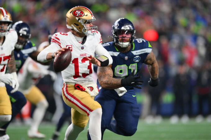 Jan 17, 2026; Seattle, WA, USA; San Francisco 49ers quarterback Brock Purdy (13) is pressured by Seattle Seahawks defensive tackle Byron Murphy II (91) during the second half in an NFC Divisional Round game at Lumen Field. Mandatory Credit: Steven Bisig-Imagn Images