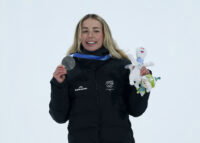 Feb 9, 2026; Livigno, Italy; Zoi Sadowski Synnott of New Zealand on the podium after the women's snowboarding big air final during the Milano Cortina 2026 Olympic Winter Games at Livigno Snow Park. Mandatory Credit: Nathan Ray Seebeck-Imagn Images