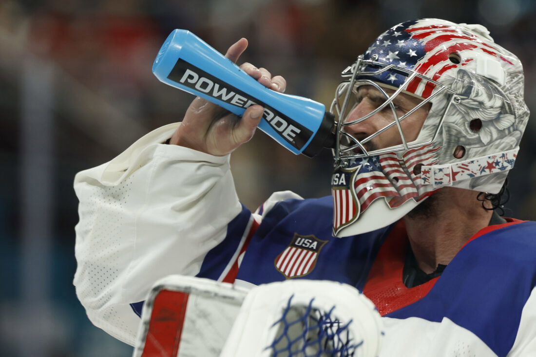Feb 22, 2026; Milan, Italy; Connor Hellebuyck (37) of Team United States drinks from a water bottle during a stoppage in play against Team Canada in the Gold Medal Game during the Milano Cortina 2026 Olympic Winter Games at Milano Santagiulia Ice Hockey Arena. Mandatory Credit: Geoff Burke-Imagn Images