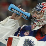 Feb 22, 2026; Milan, Italy; Connor Hellebuyck (37) of Team United States drinks from a water bottle during a stoppage in play against Team Canada in the Gold Medal Game during the Milano Cortina 2026 Olympic Winter Games at Milano Santagiulia Ice Hockey Arena. Mandatory Credit: Geoff Burke-Imagn Images