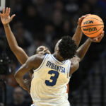 Mar 19, 2026; Portland, OR, USA; Texas Longhorns guard Tramon Mark (12) blocks BYU Cougars forward AJ Dybantsa (3) in the second half during a first round game of the men's 2026 NCAA Tournament at Moda Center. Mandatory Credit: Craig Strobeck-Imagn Images