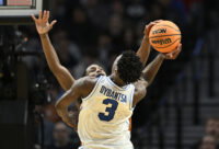 Mar 19, 2026; Portland, OR, USA; Texas Longhorns guard Tramon Mark (12) blocks BYU Cougars forward AJ Dybantsa (3) in the second half during a first round game of the men's 2026 NCAA Tournament at Moda Center. Mandatory Credit: Craig Strobeck-Imagn Images