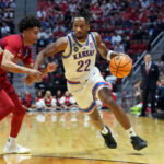Mar 22, 2026; San Diego, CA, USA; Kansas Jayhawks guard Darryn Peterson (22) controls the ball against St. John's Red Storm guard Oziyah Sellers (4) in the second half during a second round game of the men's 2026 NCAA Tournament at Viejas Arena. Mandatory Credit: Kirby Lee-Imagn Images