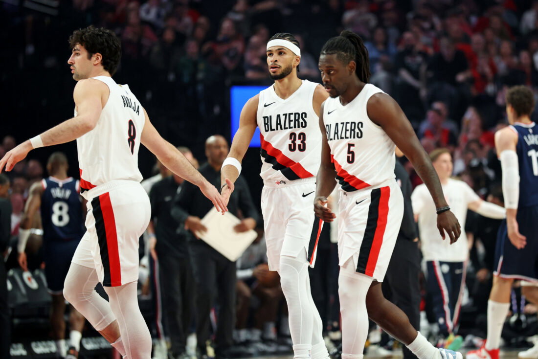 Apr 10, 2026; Portland, Oregon, USA; Portland Trail Blazers forward Deni Avdija (8) high-fives forward Toumani Camara (33) as guard Jrue Holiday (5) heads to the bench during a timeout in the first half against the LA Clippers at Moda Center. Mandatory Credit: Jaime Valdez-Imagn Images