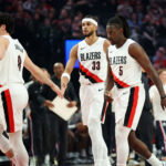 Apr 10, 2026; Portland, Oregon, USA; Portland Trail Blazers forward Deni Avdija (8) high-fives forward Toumani Camara (33) as guard Jrue Holiday (5) heads to the bench during a timeout in the first half against the LA Clippers at Moda Center. Mandatory Credit: Jaime Valdez-Imagn Images