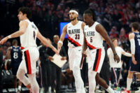 Apr 10, 2026; Portland, Oregon, USA; Portland Trail Blazers forward Deni Avdija (8) high-fives forward Toumani Camara (33) as guard Jrue Holiday (5) heads to the bench during a timeout in the first half against the LA Clippers at Moda Center. Mandatory Credit: Jaime Valdez-Imagn Images