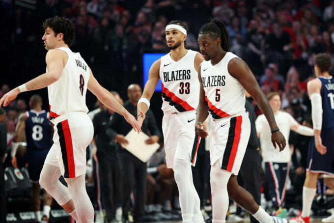 Apr 10, 2026; Portland, Oregon, USA; Portland Trail Blazers forward Deni Avdija (8) high-fives forward Toumani Camara (33) as guard Jrue Holiday (5) heads to the bench during a timeout in the first half against the LA Clippers at Moda Center. Mandatory Credit: Jaime Valdez-Imagn Images