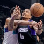 Stockton Kings’ DaQuan Jefferies, right, is fouled by Greensboro Swam’s Jonas Aidoo during the second game of the NBA G League basketball championship at the Adventist Health Arena in downtown Stockton on Apr. 10, 2026. The Kings lost 119-104.