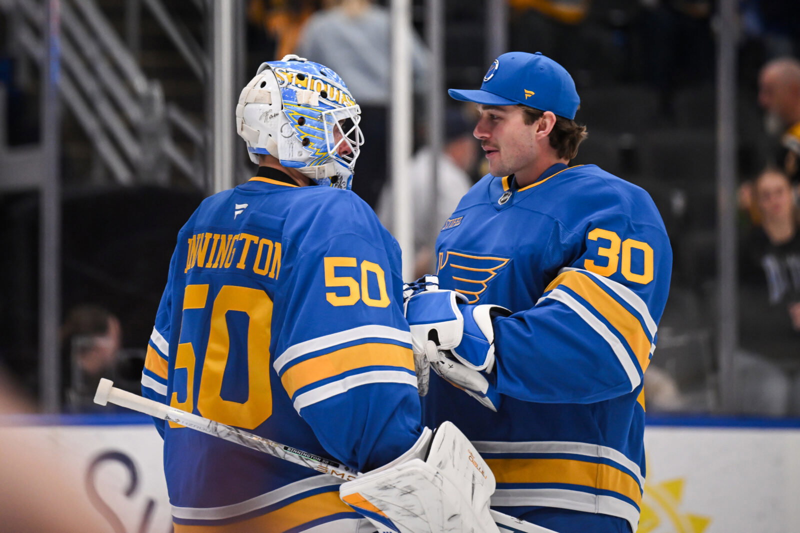 Apr 14, 2026; St. Louis, Missouri, USA; St. Louis Blues goaltender Joel Hofer (30) congratulates goaltender Jordan Binnington (50) after defeating the Pittsburgh Penguins at Enterprise Center. Mandatory Credit: Connor Hamilton-Imagn Images