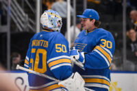 Apr 14, 2026; St. Louis, Missouri, USA; St. Louis Blues goaltender Joel Hofer (30) congratulates goaltender Jordan Binnington (50) after defeating the Pittsburgh Penguins at Enterprise Center. Mandatory Credit: Connor Hamilton-Imagn Images