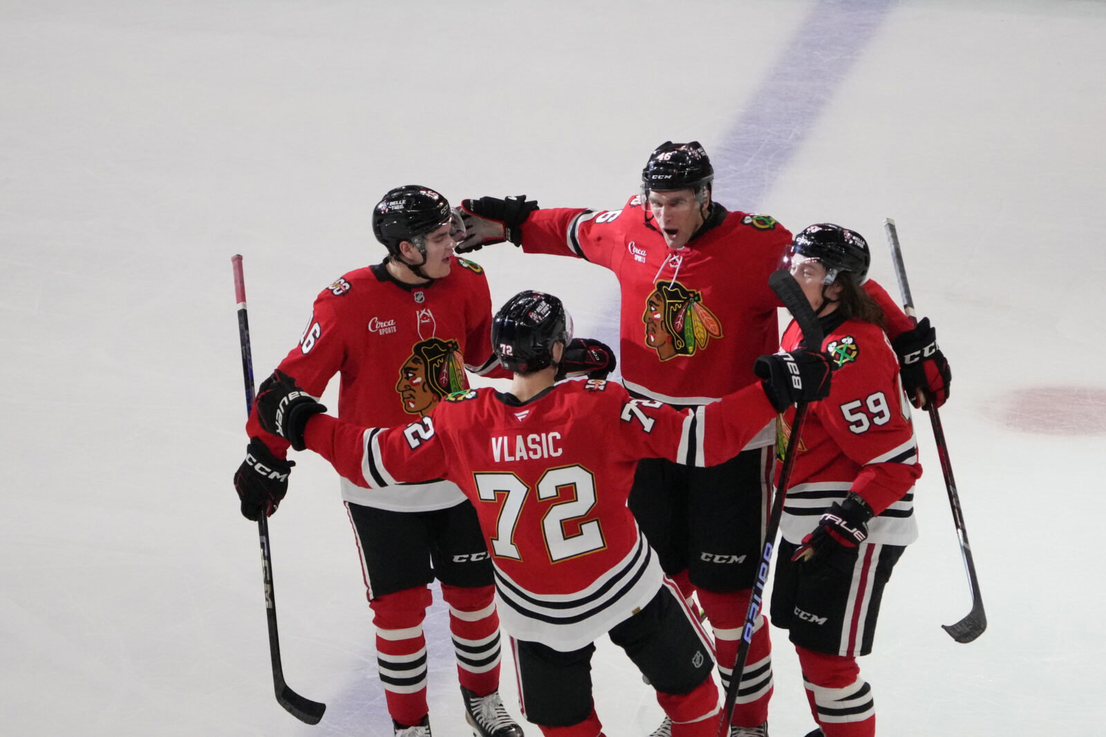 Apr 15, 2026; Chicago, Illinois, USA; Chicago Blackhawks defenseman Louis Crevier (46) celebrates his second goal against the San Jose Sharks with left wing Tyler Bertuzzi (59) during the third period at United Center. Mandatory Credit: David Banks-Imagn Images