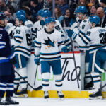 Apr 16, 2026; Winnipeg, Manitoba, CAN; San Jose Sharks forward Philipp Kurashev (96) is congratulated by his team mates on his goal against the Winnipeg Jets during the second period at Canada Life Centre. Mandatory Credit: Terrence Lee-Imagn Images