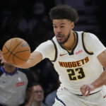 Apr 23, 2026; Minneapolis, Minnesota, USA; Denver Nuggets forward Cameron Johnson (23) goes after the ball against the Minnesota Timberwolves in the third quarter at Target Center. Mandatory Credit: Bruce Kluckhohn-Imagn Images