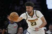 Apr 23, 2026; Minneapolis, Minnesota, USA; Denver Nuggets forward Cameron Johnson (23) goes after the ball against the Minnesota Timberwolves in the third quarter at Target Center. Mandatory Credit: Bruce Kluckhohn-Imagn Images