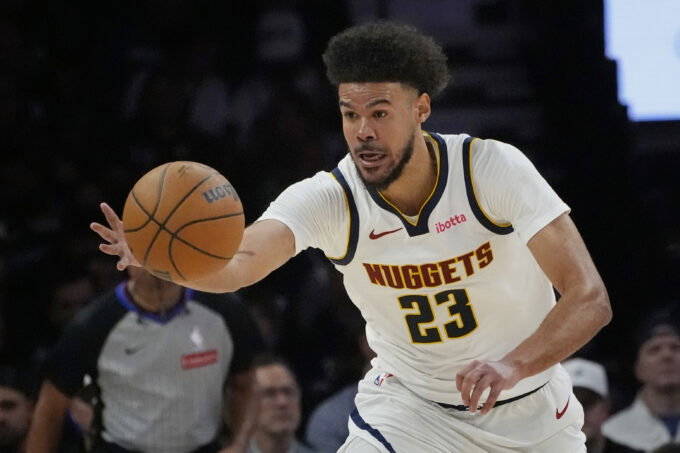 Apr 23, 2026; Minneapolis, Minnesota, USA; Denver Nuggets forward Cameron Johnson (23) goes after the ball against the Minnesota Timberwolves in the third quarter at Target Center. Mandatory Credit: Bruce Kluckhohn-Imagn Images