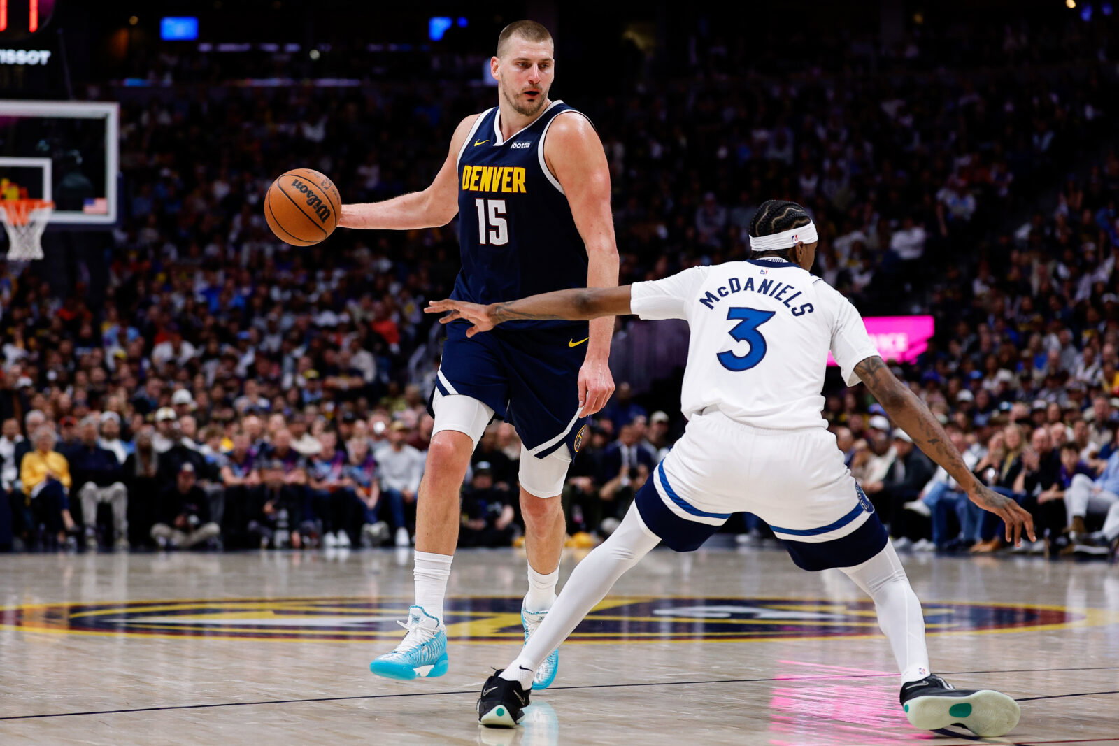 Apr 27, 2026; Denver, Colorado, USA; Denver Nuggets center Nikola Jokic (15) controls the ball as Minnesota Timberwolves forward Jaden McDaniels (3) defends in the third quarter during game five of the first round of the 2026 NBA Playoffs at Ball Arena. Mandatory Credit: Isaiah J. Downing-Imagn Images