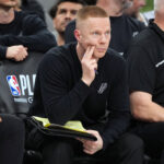 May 12, 2026; San Antonio, Texas, USA; San Antonio Spurs assistant head coach Sean Sweeney observes the second half of play during game five of the second round of the 2026 NBA Playoffs against the Minnesota Timberwolves at Frost Bank Center. Mandatory Credit: Scott Wachter-Imagn Images