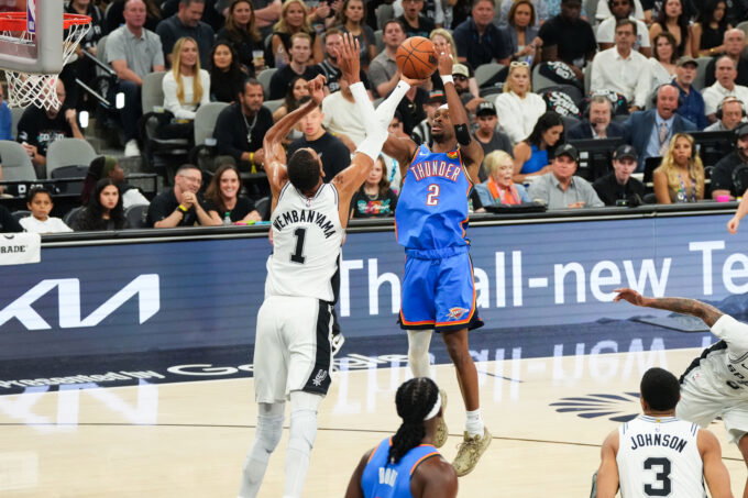 May 24, 2026; San Antonio, Texas, USA; Oklahoma City Thunder guard Shai Gilgeous-Alexander (2) shoots while defended by San Antonio Spurs center Victor Wembanyama (1) in the first quarter during game four of the western conference finals for the 2026 NBA playoffs at Frost Bank Center. Mandatory Credit: Scott Wachter-Imagn Images