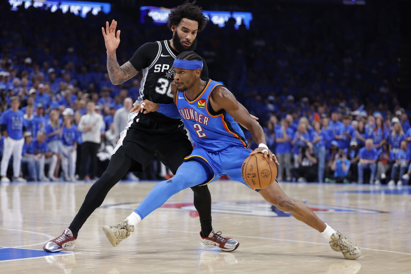 May 30, 2026; Oklahoma City, Oklahoma, USA; Oklahoma City Thunder guard Shai Gilgeous-Alexander (2) controls the ball against San Antonio Spurs forward Julian Champagnie (30) in the fourth quarter during game seven of the western conference finals for the 2026 NBA playoffs at Paycom Center. Mandatory Credit: Alonzo Adams-Imagn Images