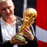 FIFA legend Bastian Schweinsteiger takes a look at the trophy during The FIFA World Cup Trophy Tour, sponsored by Coca Cola, at the American Dream Mall on Wednesday, June 3, 2026, in East Rutherford. Schweinsteiger was part of Germany’s World Cup victory in 2014.
