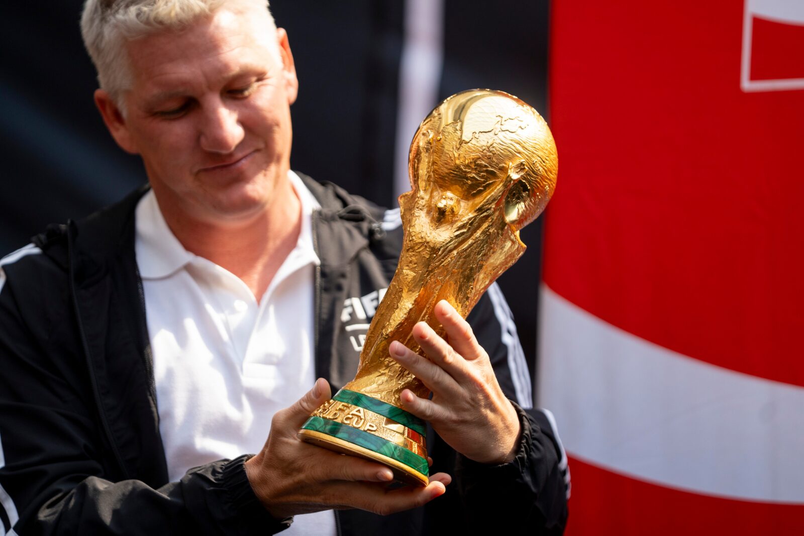 FIFA legend Bastian Schweinsteiger takes a look at the trophy during The FIFA World Cup Trophy Tour, sponsored by Coca Cola, at the American Dream Mall on Wednesday, June 3, 2026, in East Rutherford. Schweinsteiger was part of Germany’s World Cup victory in 2014.
