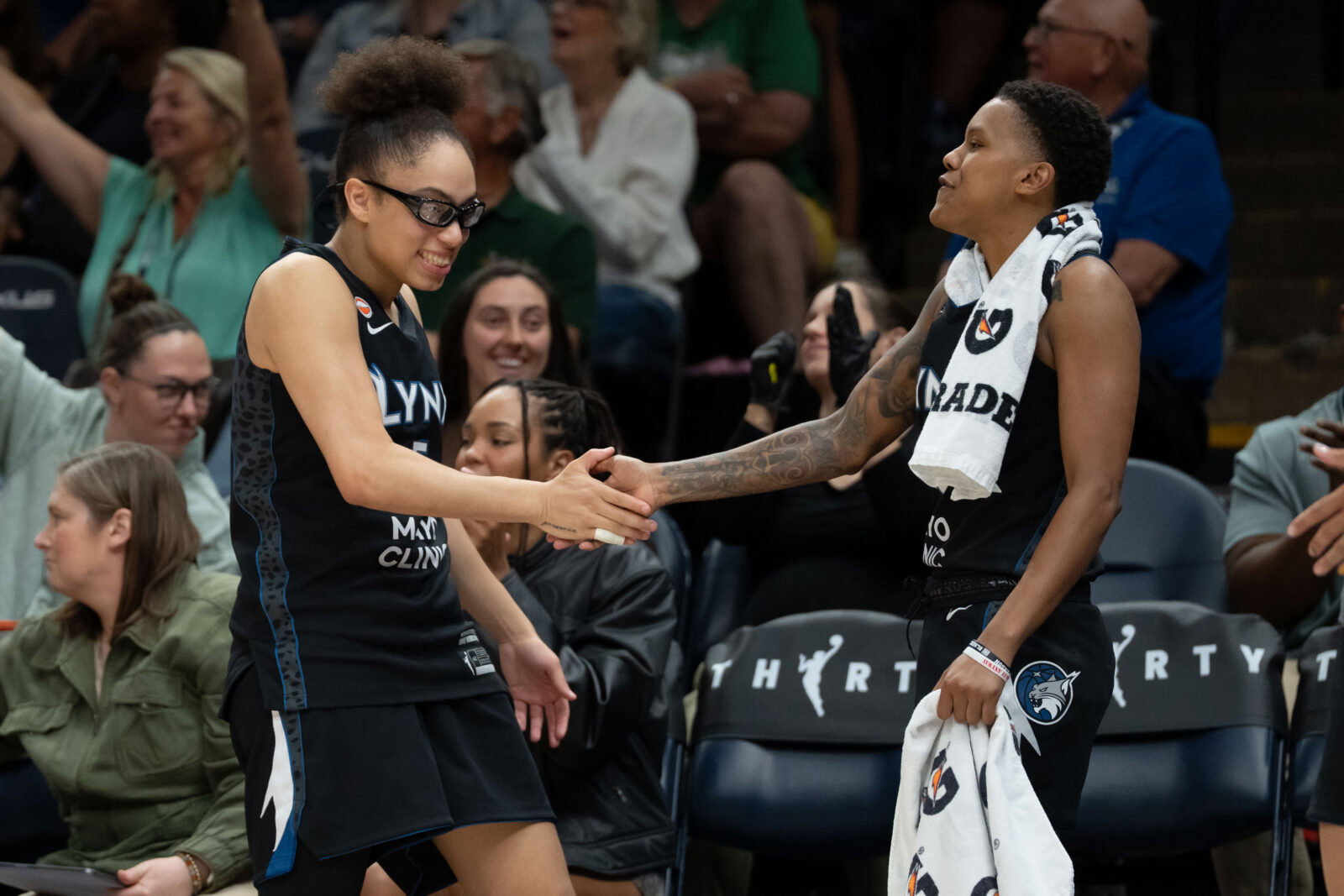 Jun 15, 2026; Minneapolis, Minnesota, USA; Minnesota Lynx guard Courtney Williams (10) and guard Olivia Miles (5) celebrates a teammate making a shot against the Portland Fire in the second half at Target Center. Mandatory Credit: Jesse Johnson-Imagn Images