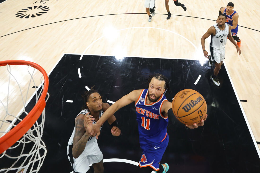 Jun 13, 2026; San Antonio, Texas, USA; New York Knicks guard Jalen Brunson (11) shoots as San Antonio Spurs guard Devin Vassell (24) defends during game five of the 2026 NBA Finals at Frost Bank Center. Mandatory Credit: Geoff Burke-Imagn Images