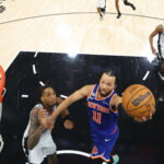 Jun 13, 2026; San Antonio, Texas, USA; New York Knicks guard Jalen Brunson (11) shoots as San Antonio Spurs guard Devin Vassell (24) defends during game five of the 2026 NBA Finals at Frost Bank Center. Mandatory Credit: Geoff Burke-Imagn Images