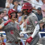 Jun 17, 2026; Omaha, NE, USA; Oklahoma Sooners right fielder Dasan Harris (17) celebrates with second baseman Kyle Branch (6) after hitting a home run against the Georgia Bulldogs during the eighth inning at Charles Schwab Field. Mandatory Credit: Steven Branscombe-Imagn Images