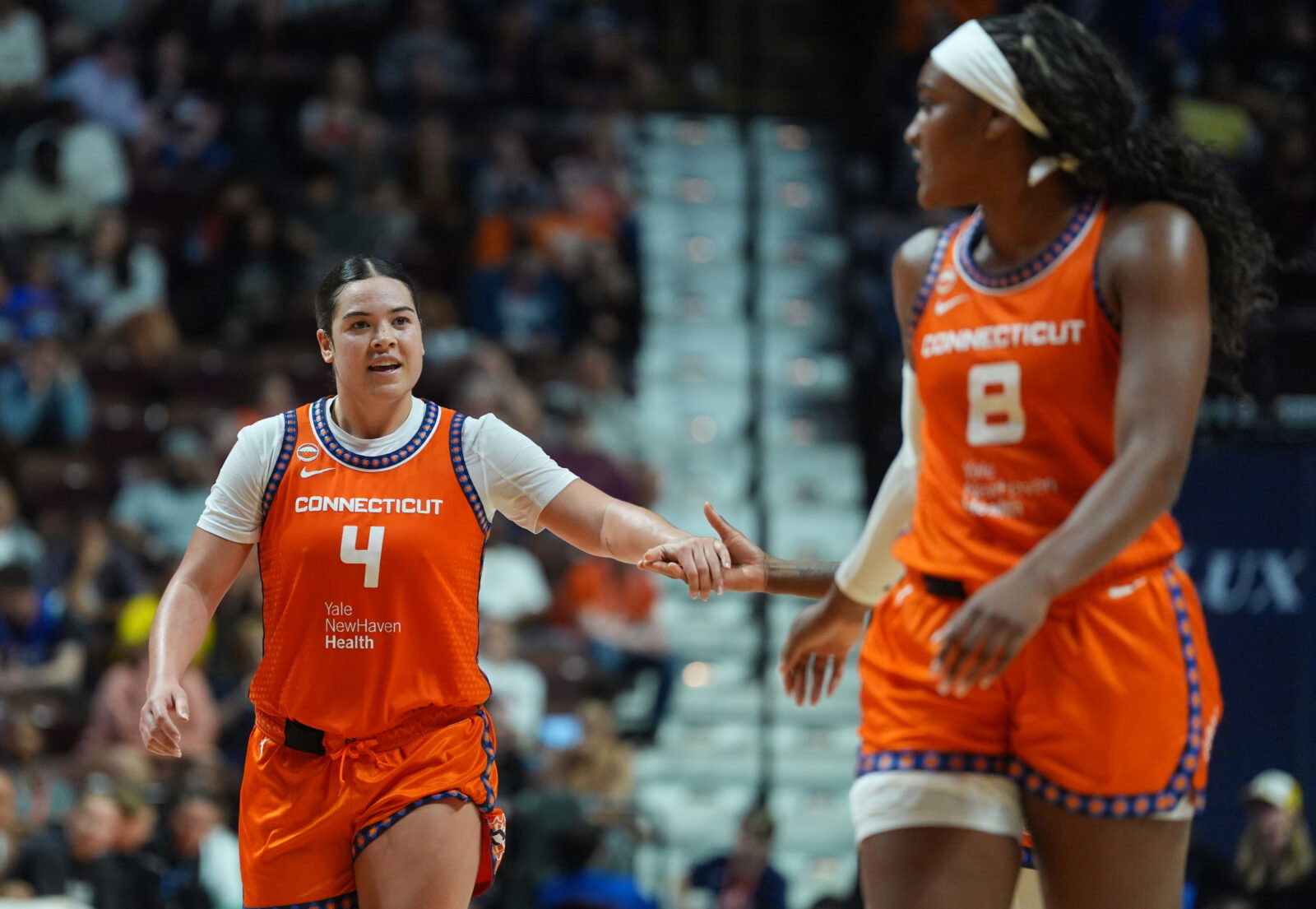Jun 22, 2026; Uncasville, Connecticut, USA; Connecticut Sun guard Charlisse Leger-Walker (4) reacts with teammates after a play against the Chicago Sky in the second half at Mohegan Sun Arena. Mandatory Credit: David Butler II-Imagn Images