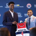 Jun 25, 2026; Washington, DC, USA; Washington Wizards first round draft pick and number one overall pick AJ Dybantsa (left) poses for a photo with his jersey and Wizards general manager Will Dawkins (right) during a press conference at InterContinental Hotel. Mandatory Credit: Amber Searls-Imagn Images
