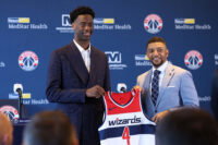 Jun 25, 2026; Washington, DC, USA; Washington Wizards first round draft pick and number one overall pick AJ Dybantsa (left) poses for a photo with his jersey and Wizards general manager Will Dawkins (right) during a press conference at InterContinental Hotel. Mandatory Credit: Amber Searls-Imagn Images