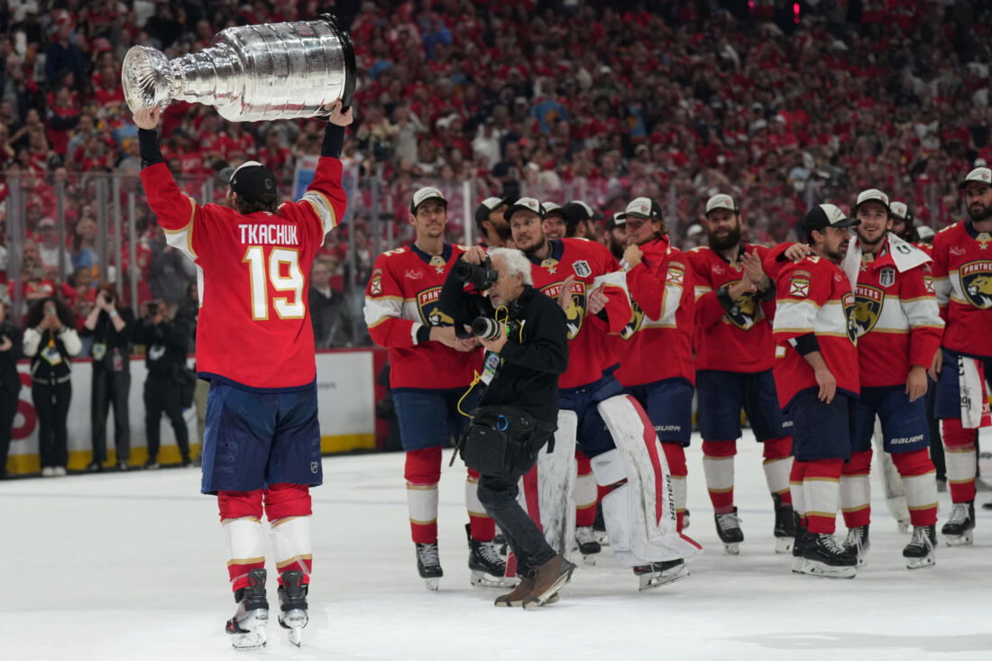 Jun 17, 2025; Sunrise, Florida, USA; Florida Panthers left wing Matthew Tkachuk (19) hoist the Stanley Cup after game six of the 2025 Stanley Cup Final against the Edmonton Oilers at Amerant Bank Arena. Mandatory Credit: Jim Rassol-Imagn Images