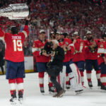 Jun 17, 2025; Sunrise, Florida, USA; Florida Panthers left wing Matthew Tkachuk (19) hoist the Stanley Cup after game six of the 2025 Stanley Cup Final against the Edmonton Oilers at Amerant Bank Arena. Mandatory Credit: Jim Rassol-Imagn Images