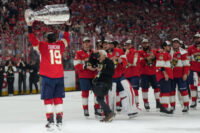 Jun 17, 2025; Sunrise, Florida, USA; Florida Panthers left wing Matthew Tkachuk (19) hoist the Stanley Cup after game six of the 2025 Stanley Cup Final against the Edmonton Oilers at Amerant Bank Arena. Mandatory Credit: Jim Rassol-Imagn Images