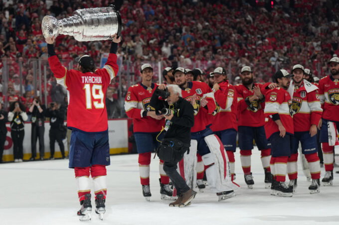 Jun 17, 2025; Sunrise, Florida, USA; Florida Panthers left wing Matthew Tkachuk (19) hoist the Stanley Cup after game six of the 2025 Stanley Cup Final against the Edmonton Oilers at Amerant Bank Arena. Mandatory Credit: Jim Rassol-Imagn Images