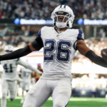 Oct 19, 2025; Arlington, Texas, USA; Dallas Cowboys cornerback Daron Bland (26) carries the ball after an interception for a touchdown against the Washington Commanders during the third quarter of the game at AT&T Stadium. Mandatory Credit: Kevin Jairaj-Imagn Images