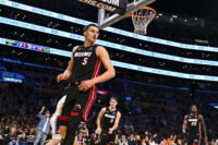 Nov 2, 2025; Los Angeles, California, USA; Miami Heat forward Nikola Jovic (5) looks to the sidelines with guard Pelle Larsson (9) and guard Davion Mitchell (45) against the Los Angeles Lakers during the second half at Crypto.com Arena. Mandatory Credit: Jonathan Hui-Imagn Images